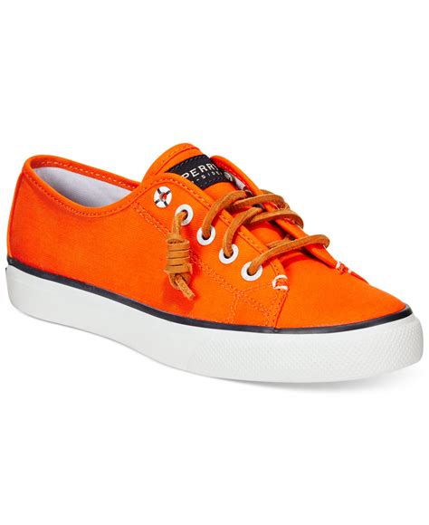 orange canvas sneakers.